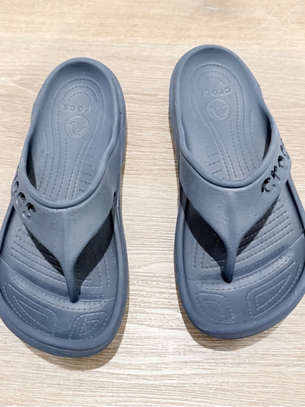 Worn navy blue crocs flip flops